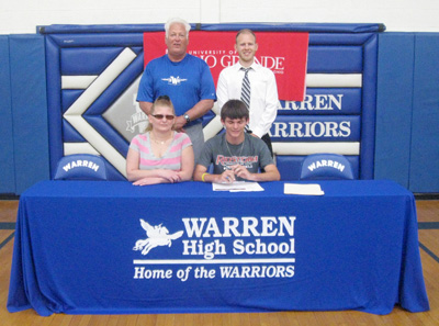 Warren Local High's Adrian Shields is joined by family and coaches for a photo after signing with Rio Grande